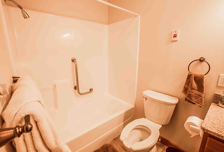 A cozy bathroom with a shower and toilet.