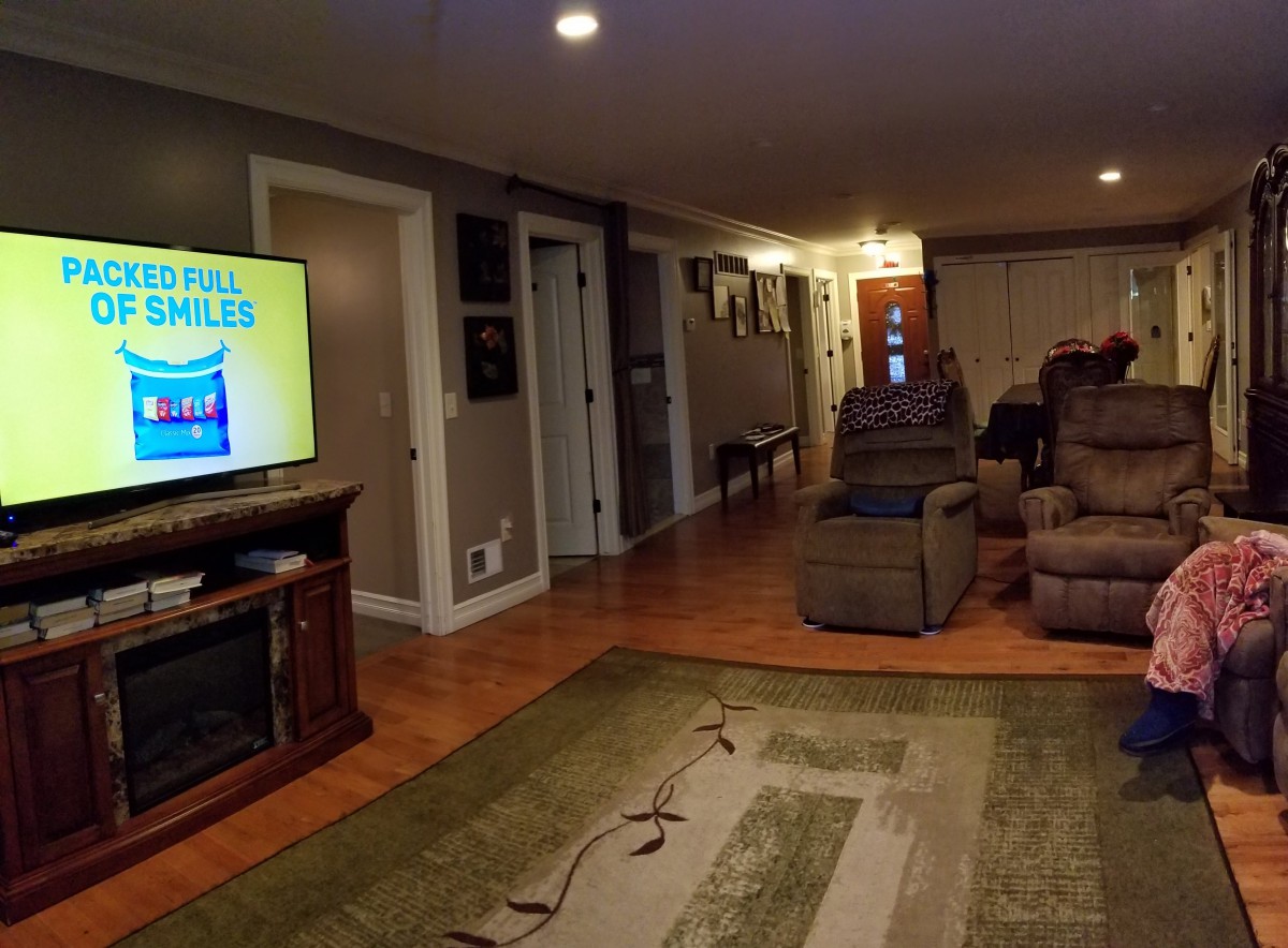 A cozy living room with a large TV and comfortable recliners.