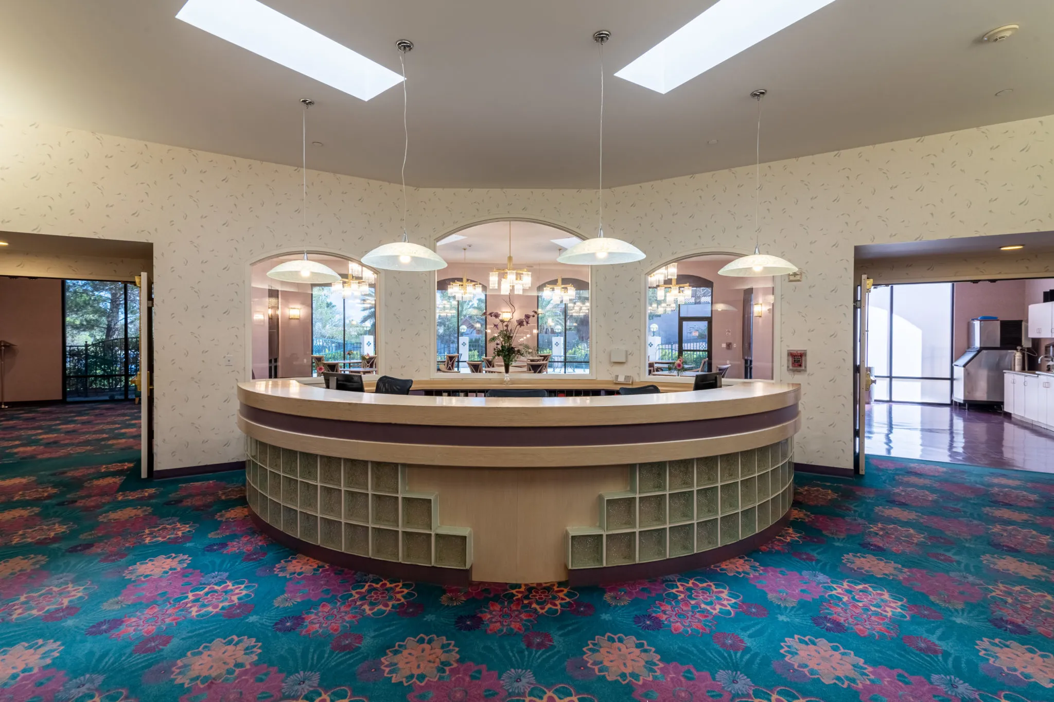 An elegant reception desk with stylish lighting in a hotel lobby.