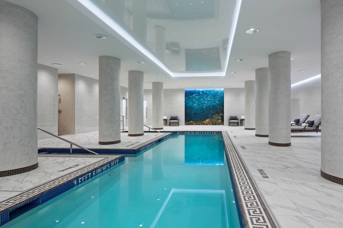 A luxurious indoor swimming pool with modern design features.