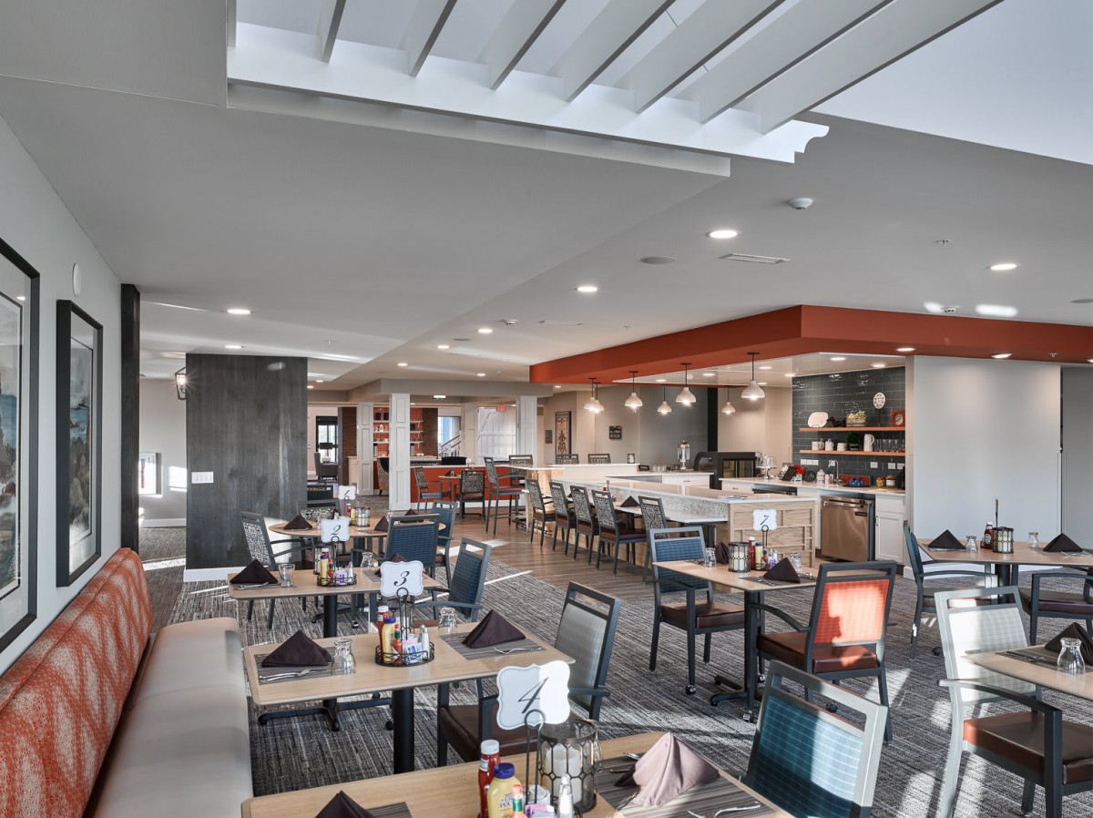 A modern restaurant interior with neatly arranged tables and chairs.