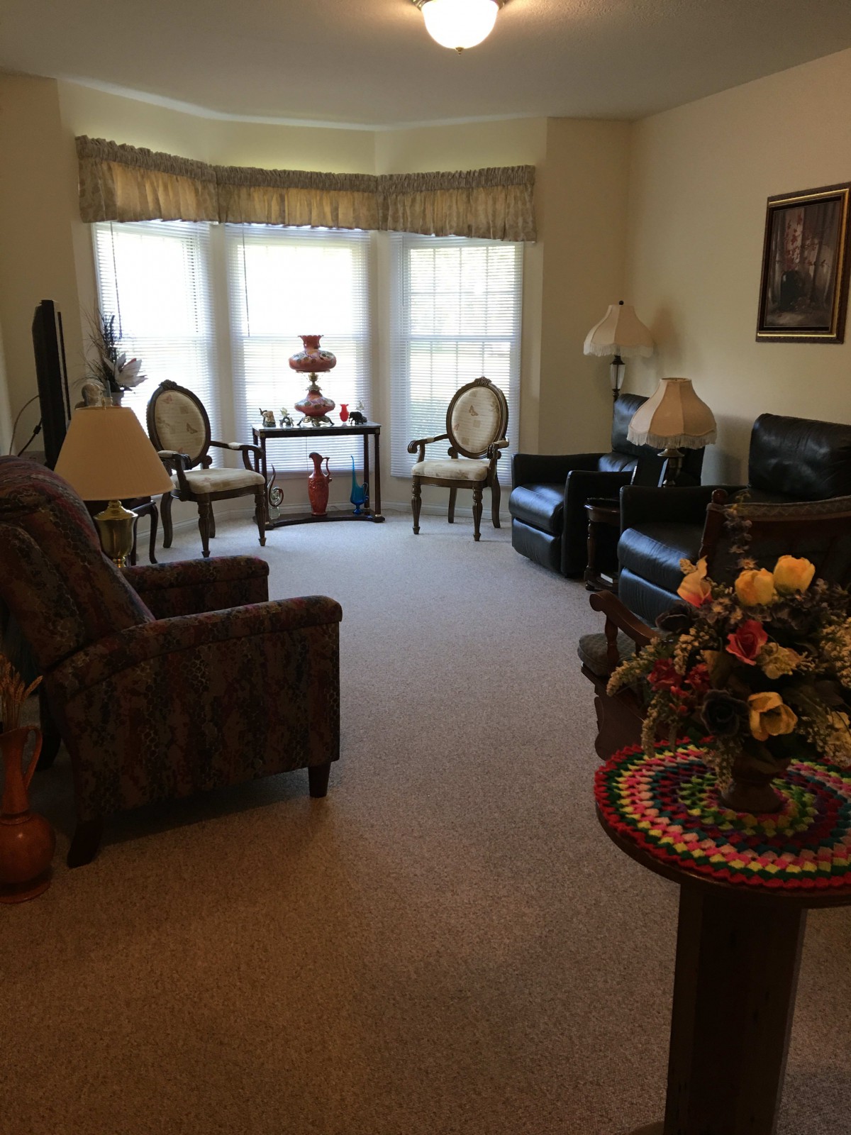 A cozy living room with classic furniture and decorative elements.