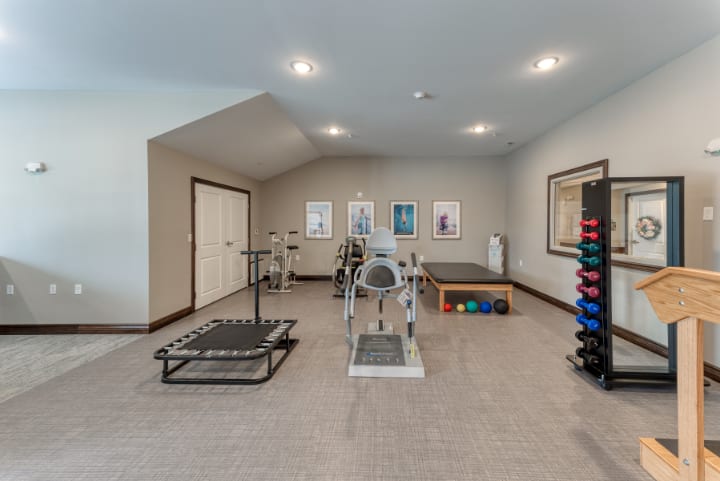 A well-equipped indoor gym space with exercise machines and fitness gear.