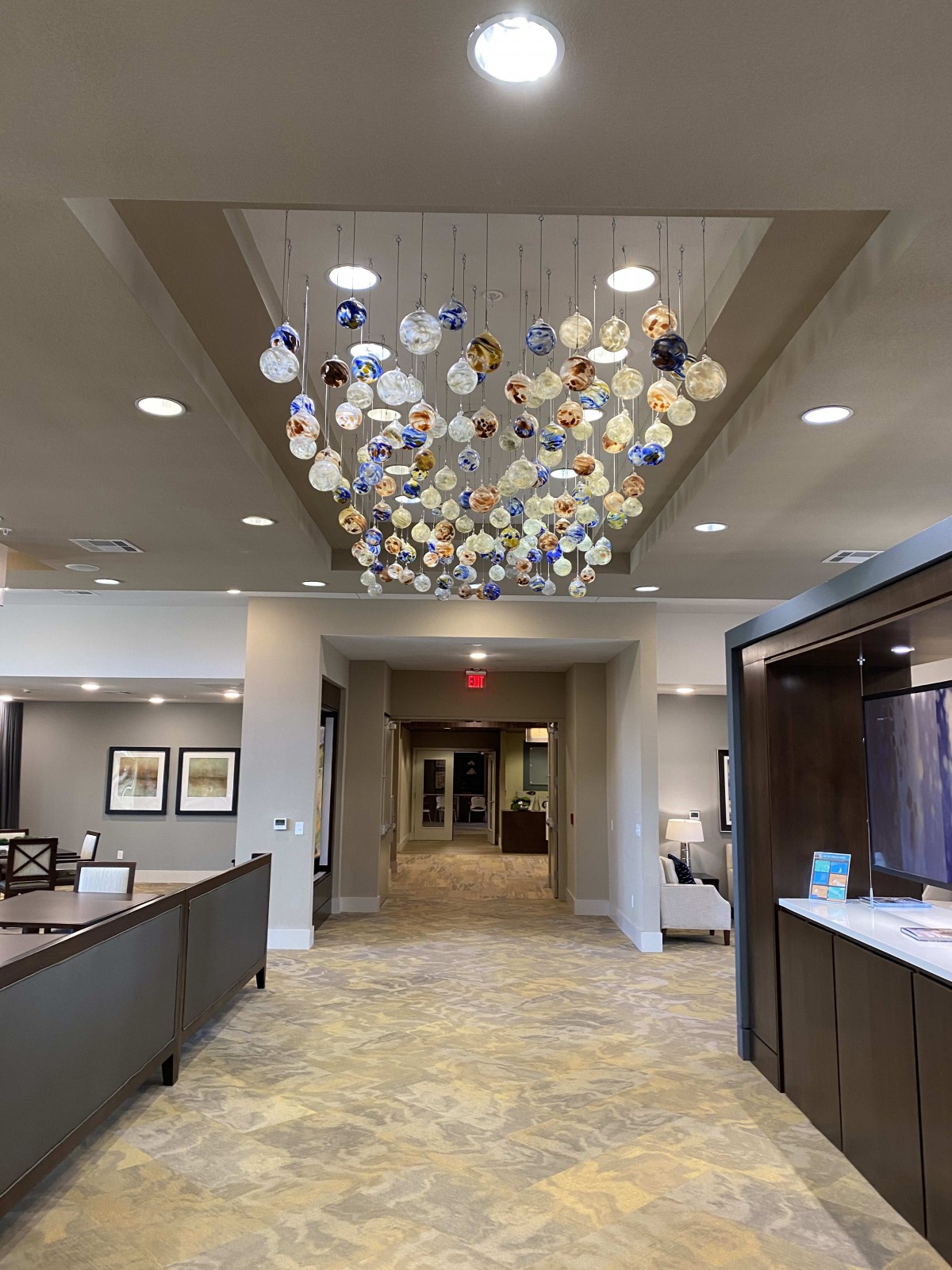 A modern lobby features a unique chandelier art installation.