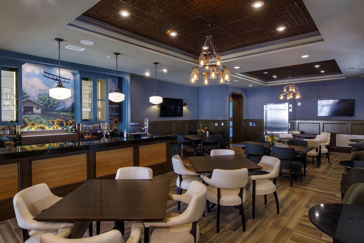 A modern restaurant dining area with stylish lighting and comfortable seating.