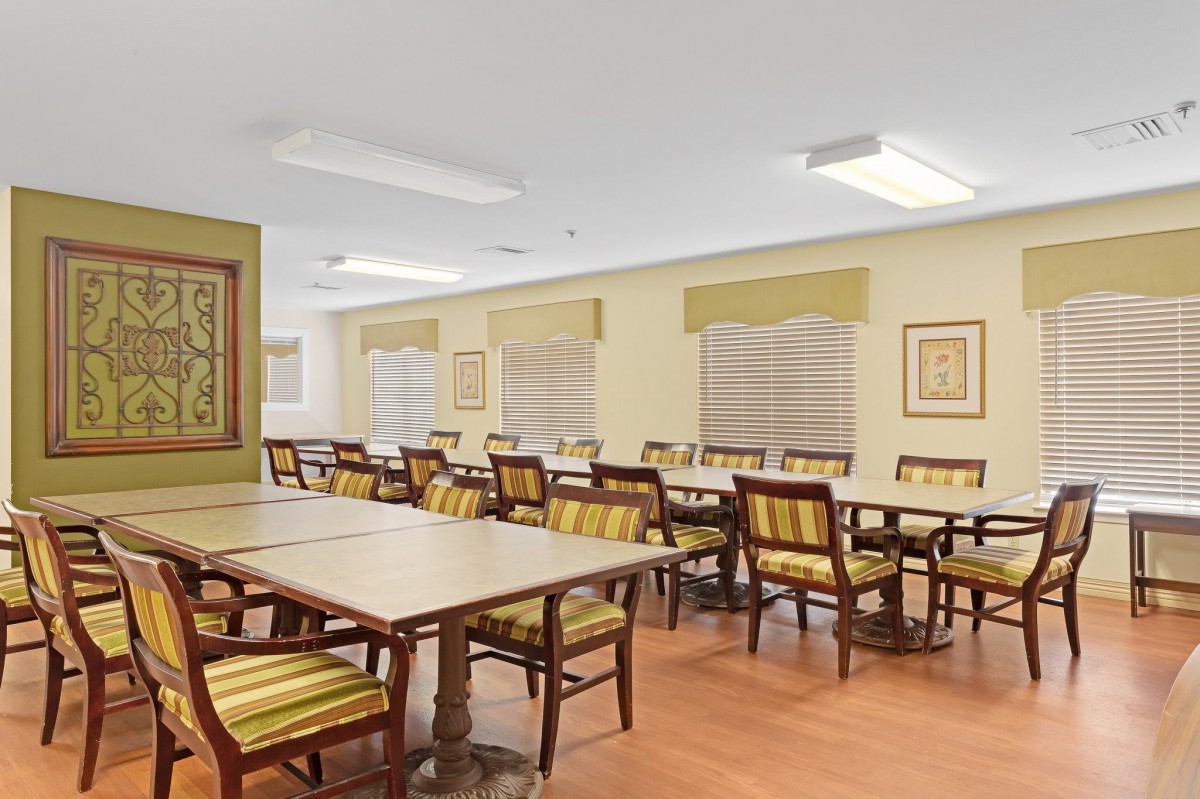 An empty dining area with neatly arranged tables and chairs.
