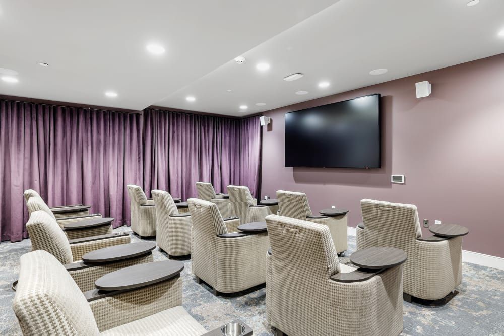 A luxurious home theater with comfortable seating and a large screen.