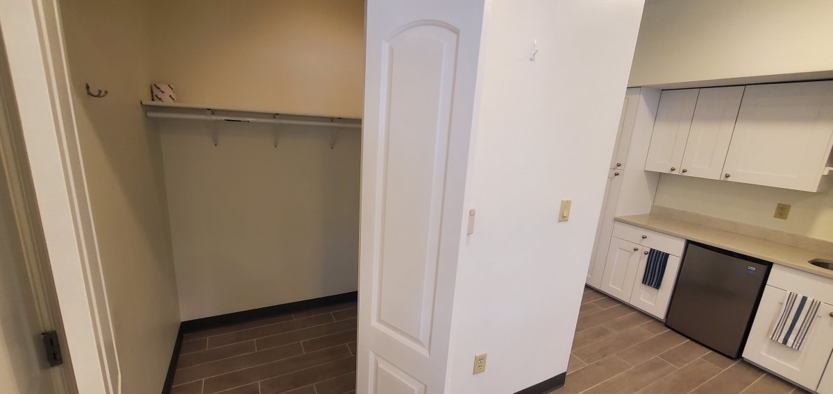 A white door positioned in an unusual way within a room creates an optical illusion.
