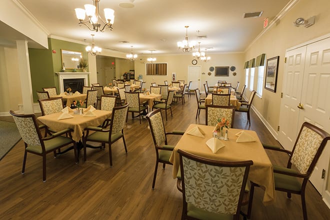 A spacious dining room with arranged tables and elegant decor.