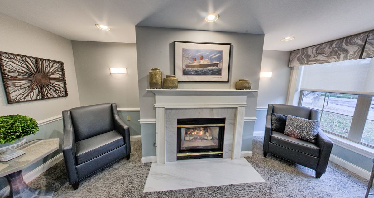 A modern living room with a cozy fireplace and comfortable seating.