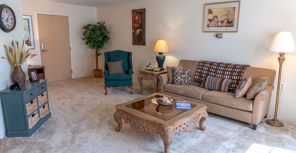 Cozy living room with classic furniture and warm lighting.