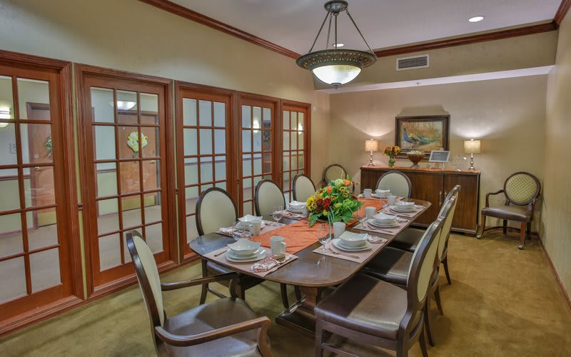 A beautifully set dining room table with elegant decor and warm lighting.