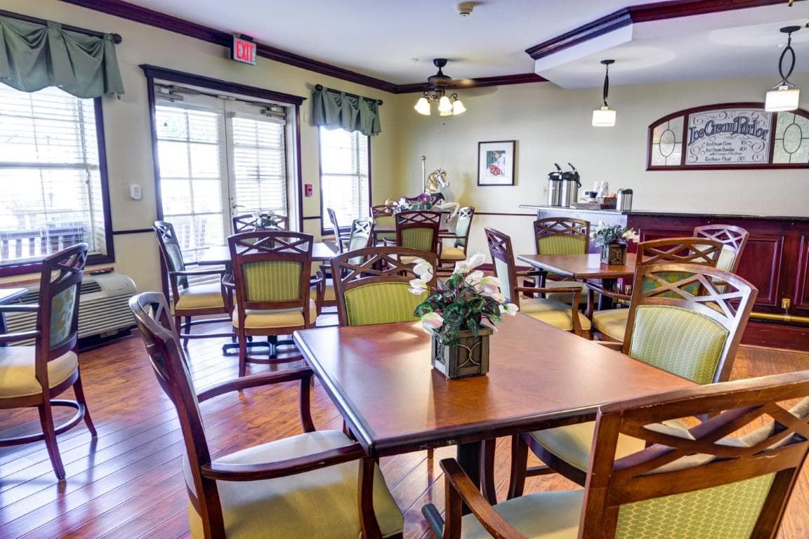 A cozy dining room with wooden tables and chairs, elegantly decorated.