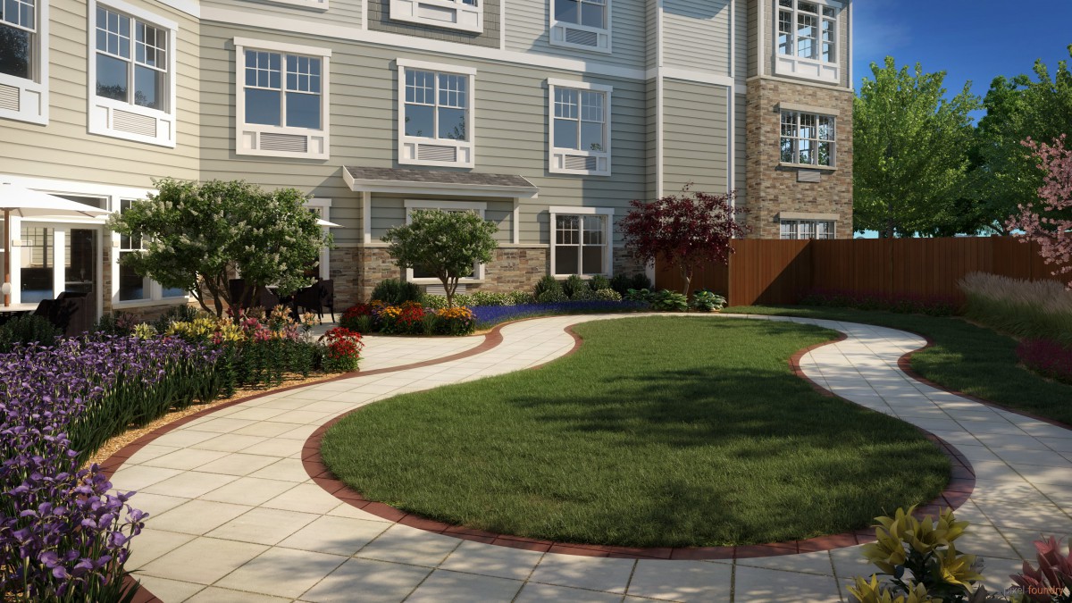 A well-maintained garden with a curved pathway and neatly trimmed lawn in front of a residential building.