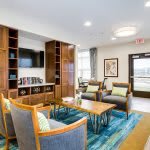 A modern living room with wooden furniture and a cozy seating area.