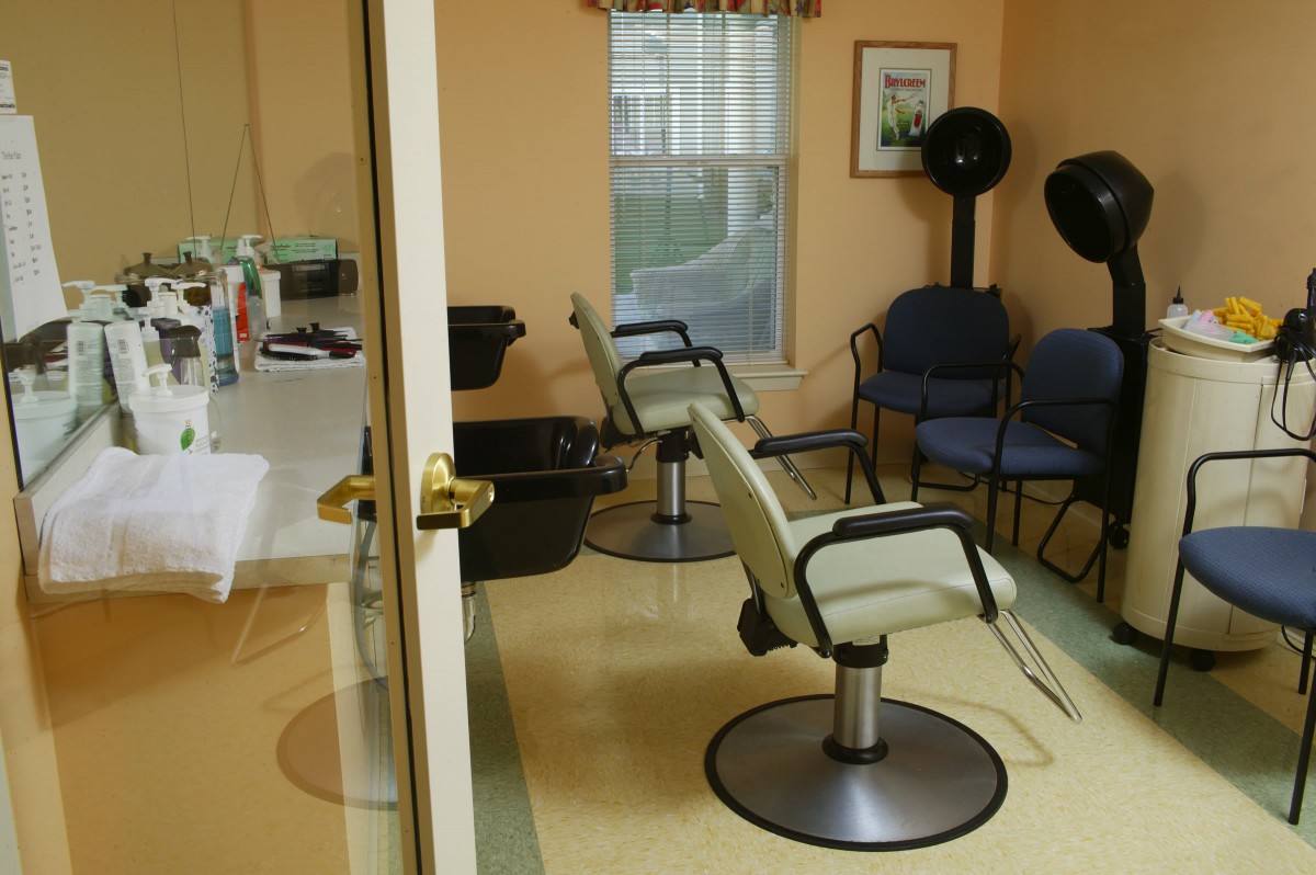 An interior view of a hair salon with styling chairs and equipment.