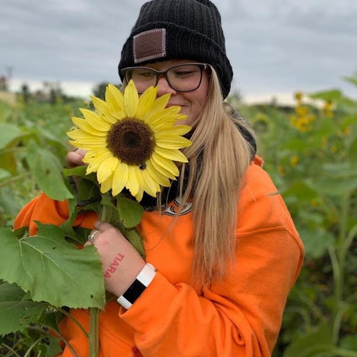 A joyful moment in a sunflower field, embracing nature's beauty.