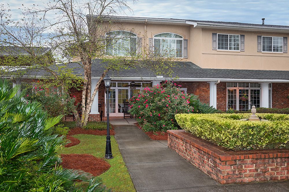 A beautiful two-story house with well-maintained landscaping and a welcoming pathway.
