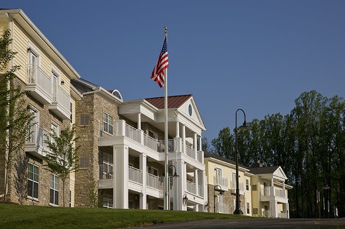 A residential building with an American flag on a clear day.