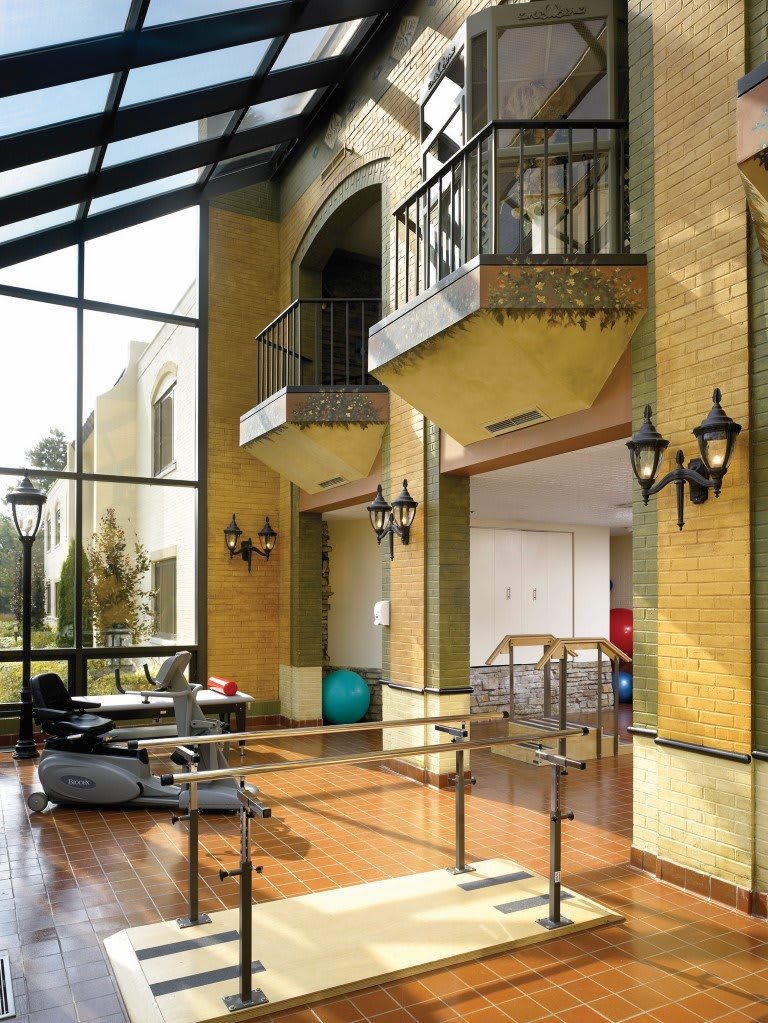 A modern interior space with therapy equipment and a glass ceiling.