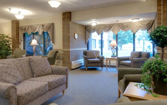 A cozy living room with comfortable seating and large windows.