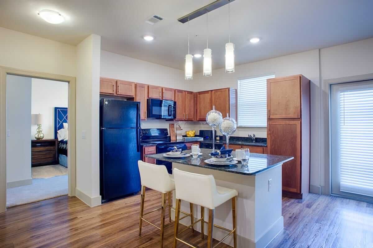 Modern kitchen with a central island and wooden cabinets.