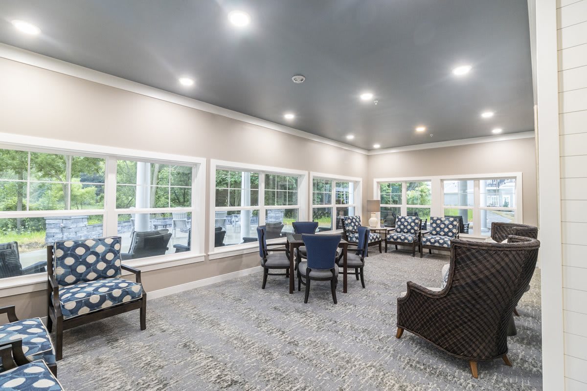 A spacious and well-lit living room with comfortable seating and large windows.