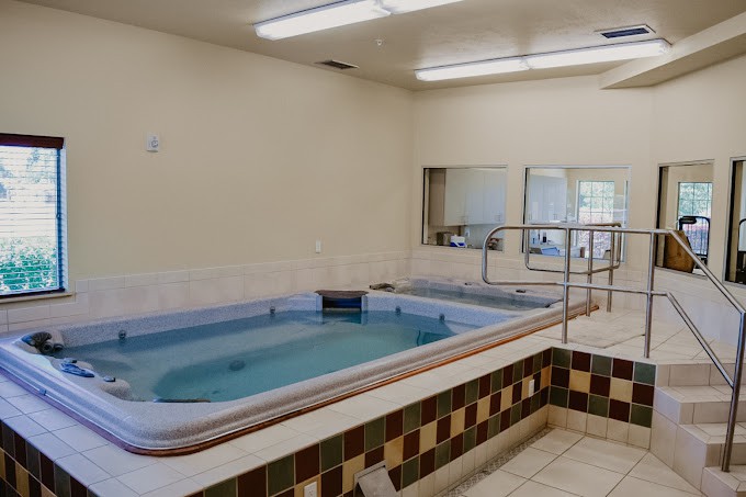 An indoor therapy pool with tiled flooring, designed for rehabilitation and hydrotherapy.