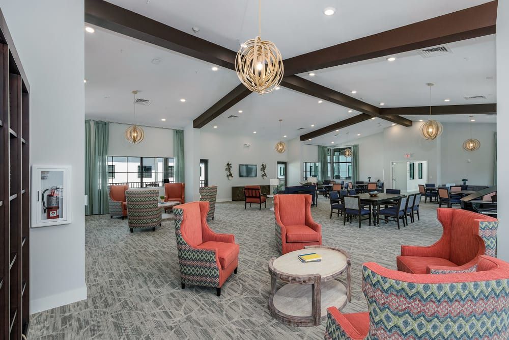 A modern lounge with vibrant seating and elegant chandeliers.