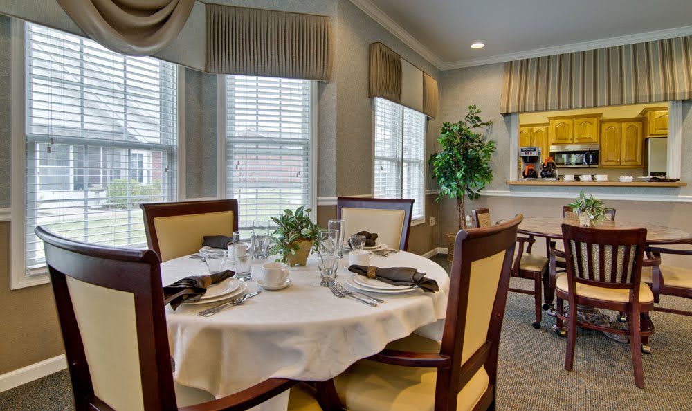 An elegant dining room with a beautifully set table and tasteful decor.