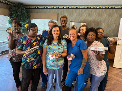 A joyful moment shared by a dedicated healthcare team celebrating together.