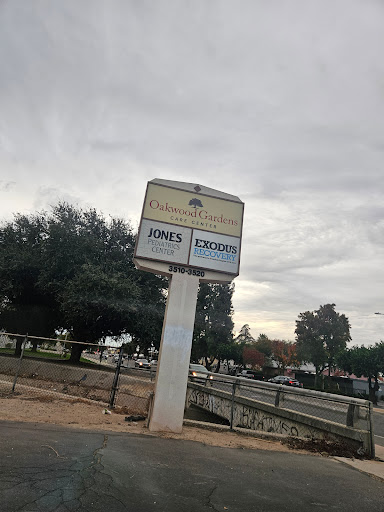 A business sign displaying 'JON'S EXCAVATION' against a cloudy backdrop.
