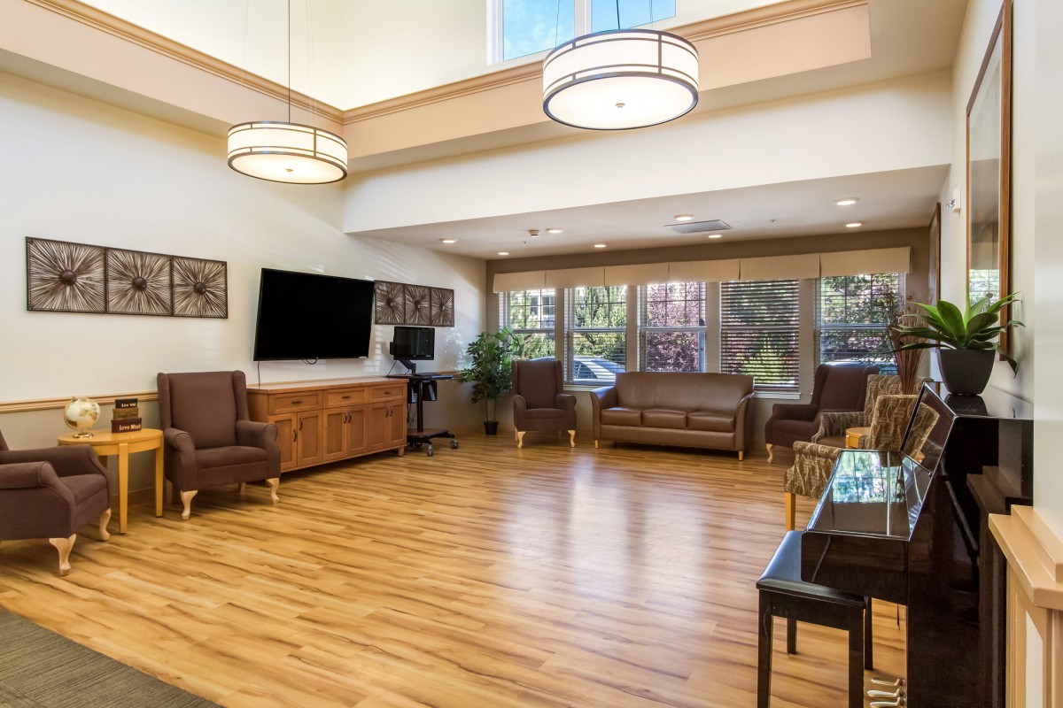 A spacious living room with modern furniture and large windows.