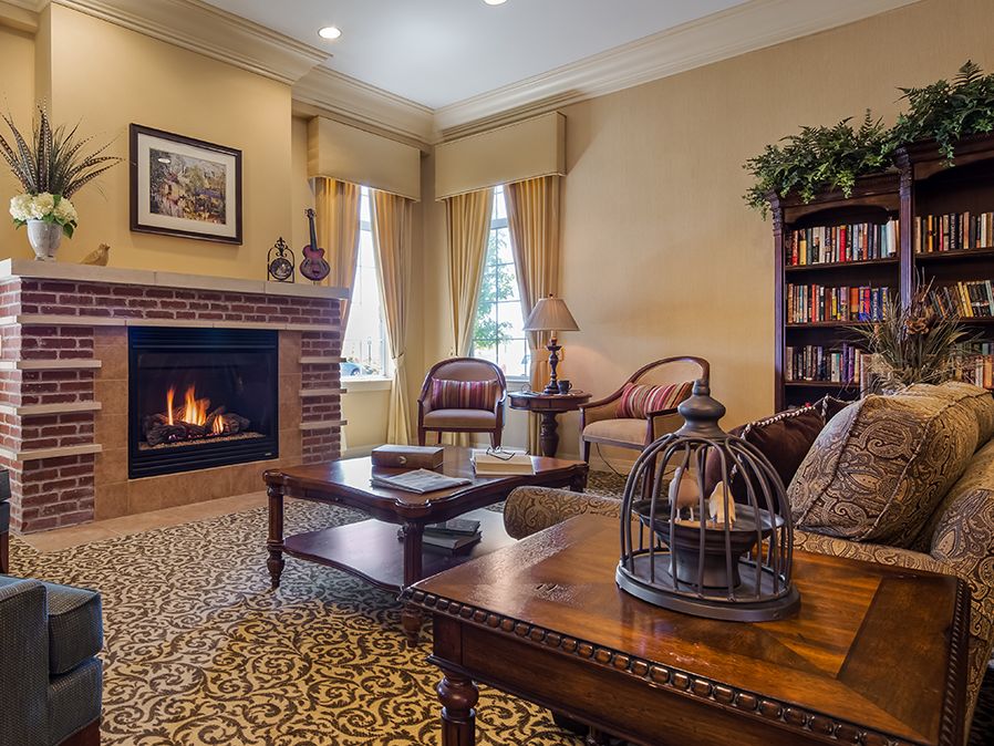 A cozy living room with a warm fireplace and traditional decor.