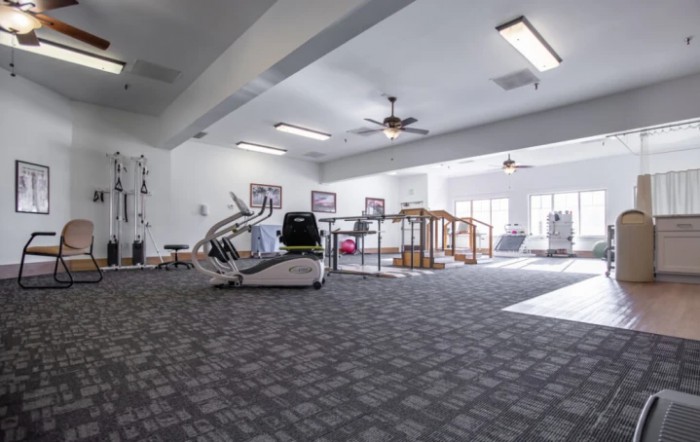 A spacious gym with various exercise equipment.