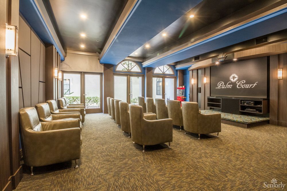 A modern indoor theater with comfortable seating and a large screen.