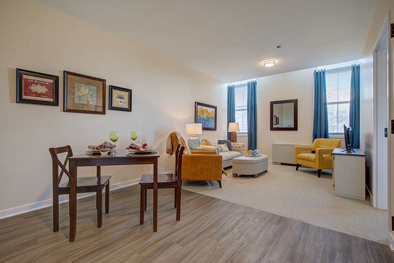 A modern living and dining area with stylish decor and furniture.