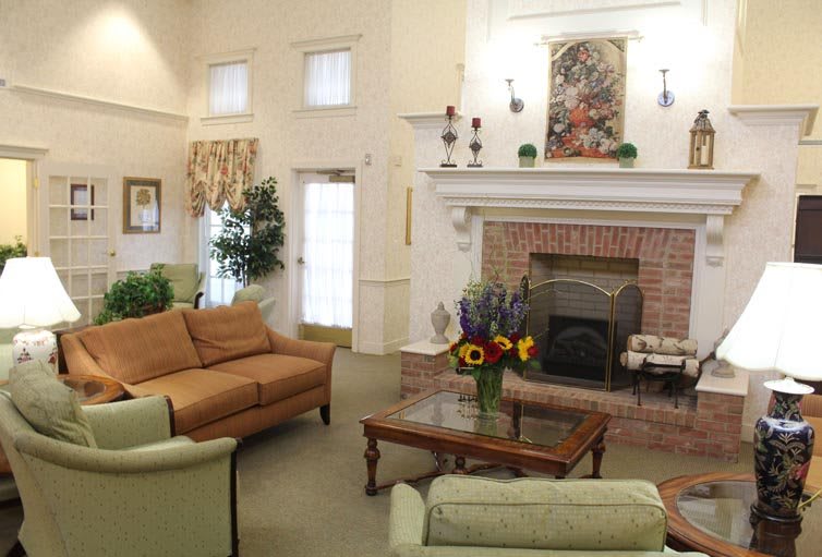 A cozy living room with a brick fireplace and comfortable seating.