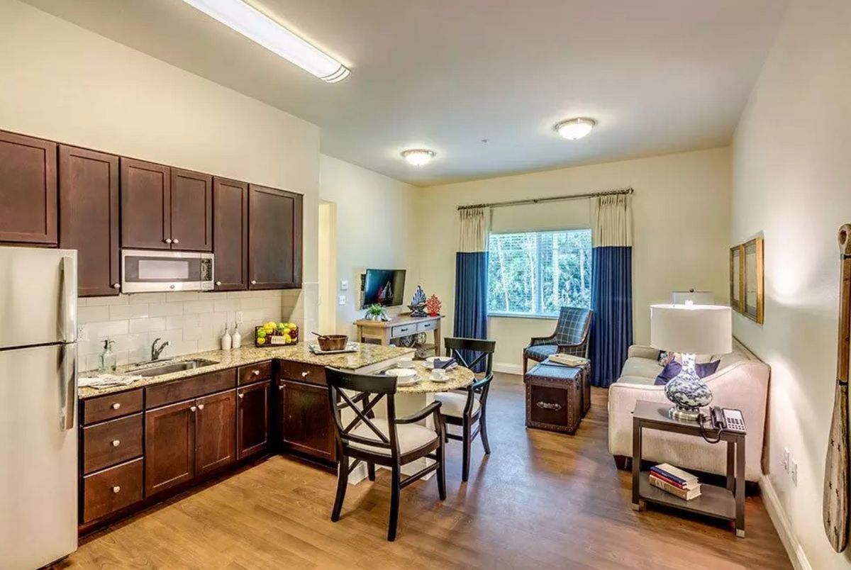 A modern apartment featuring an open kitchen and living area with stylish furnishings.