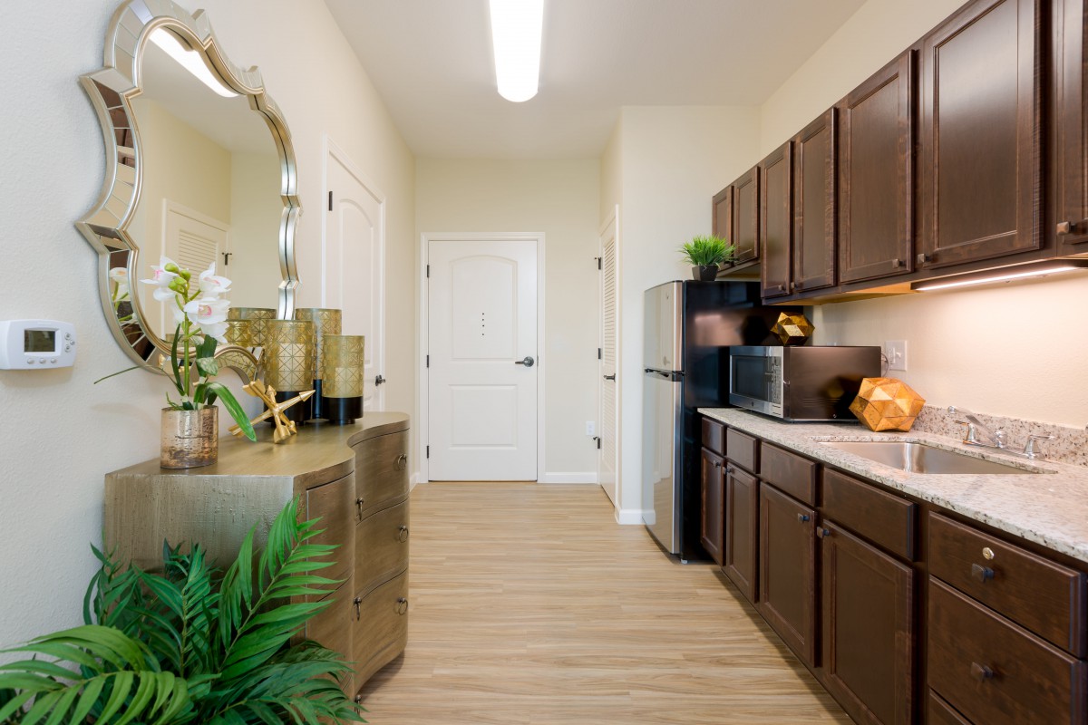 A modern kitchen with wooden cabinets and minimalist decor.