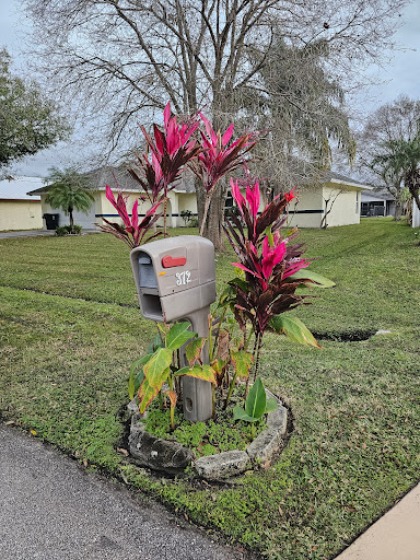 A vibrant mailbox adorned with colorful flowers, adding charm to the residential landscape.