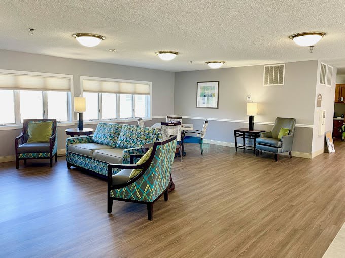 A spacious living room with comfortable seating and large windows.