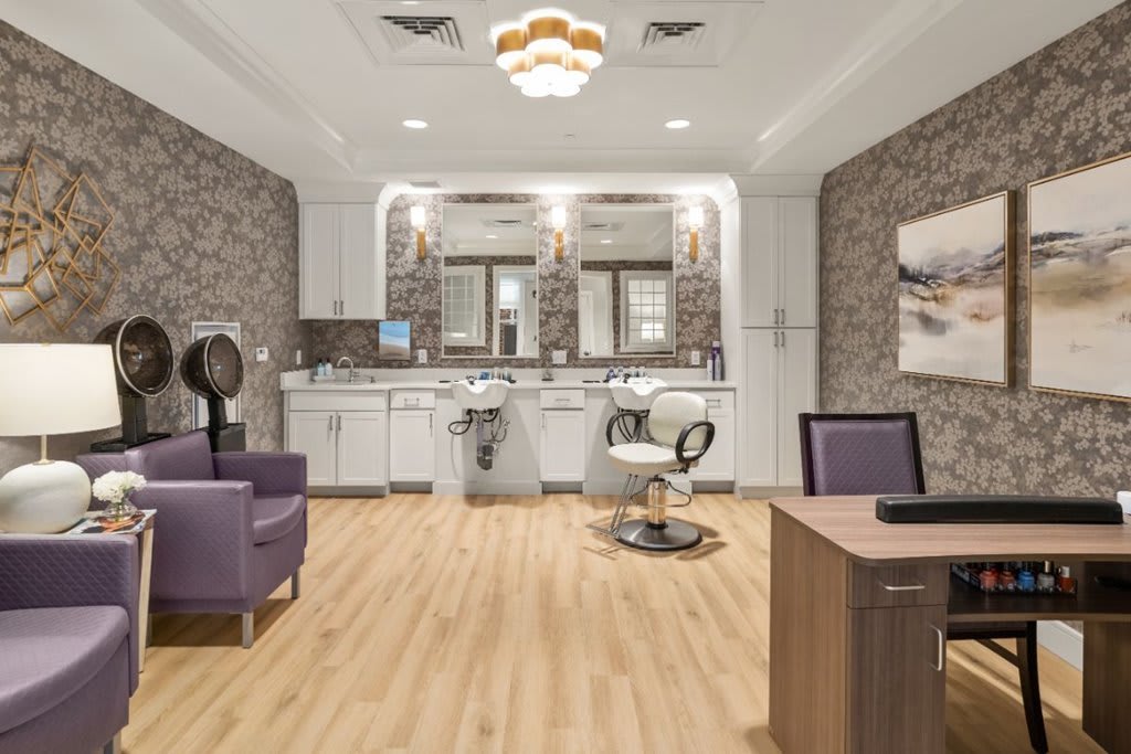 A modern hair salon interior with stylish decor and comfortable seating.