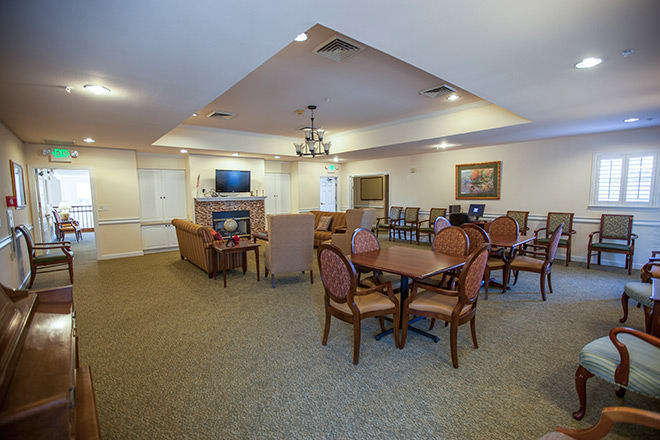 A spacious interior living room with dining area, featuring comfortable seating and a television.