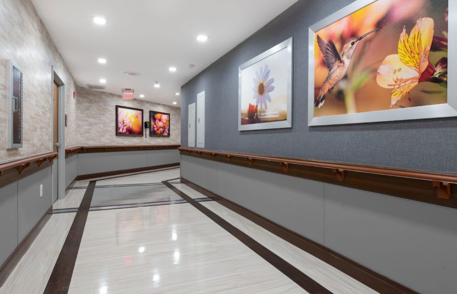 A modern hallway with framed artwork and warm lighting.