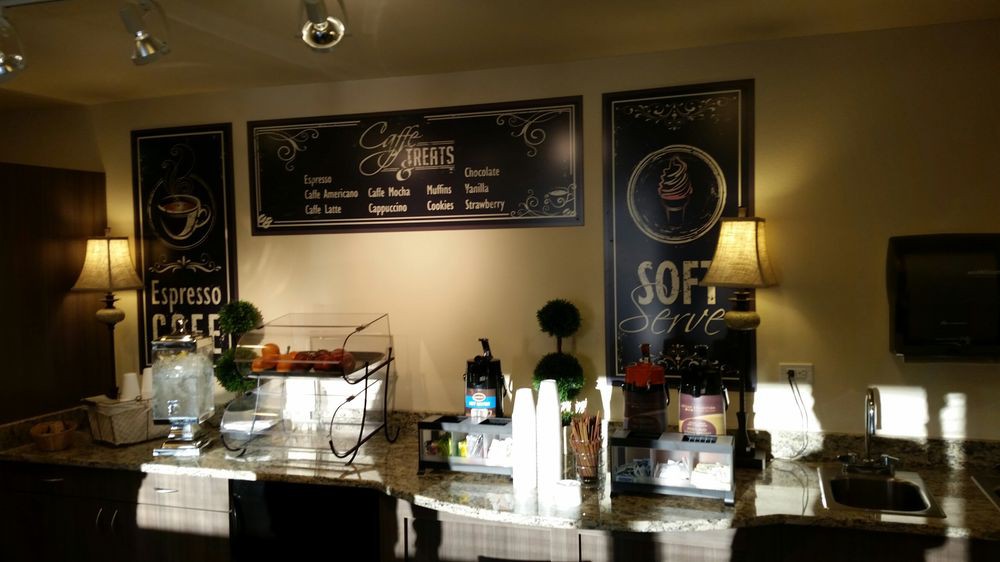 Interior view of a cafe with menu signs and a service counter.