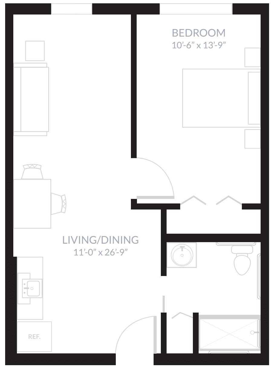 A simple apartment floor plan showing a living/dining area, bedroom, and bathroom.