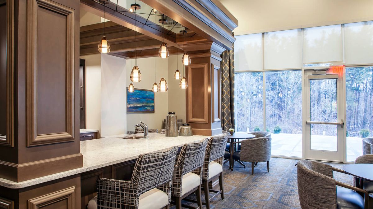 A modern luxury kitchen interior with elegant lighting and bar seating.