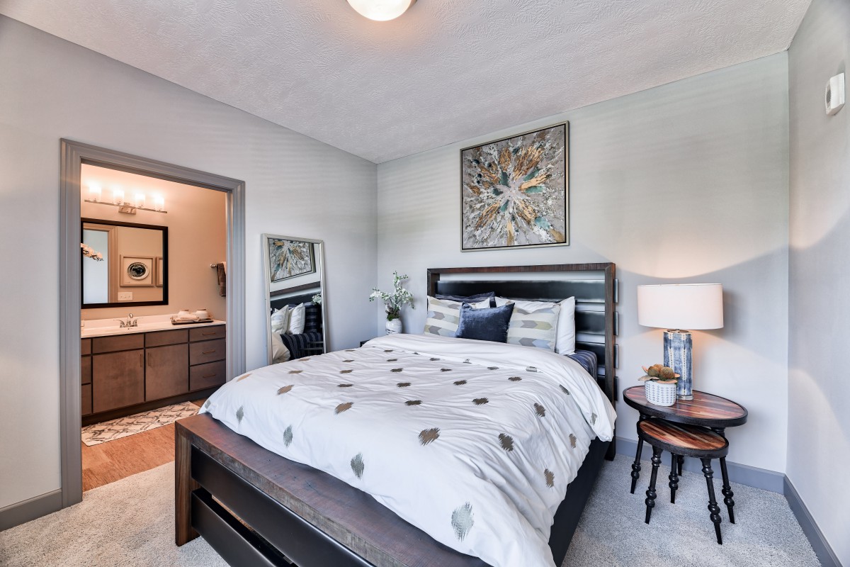 A well-decorated bedroom with modern furnishings and artwork.