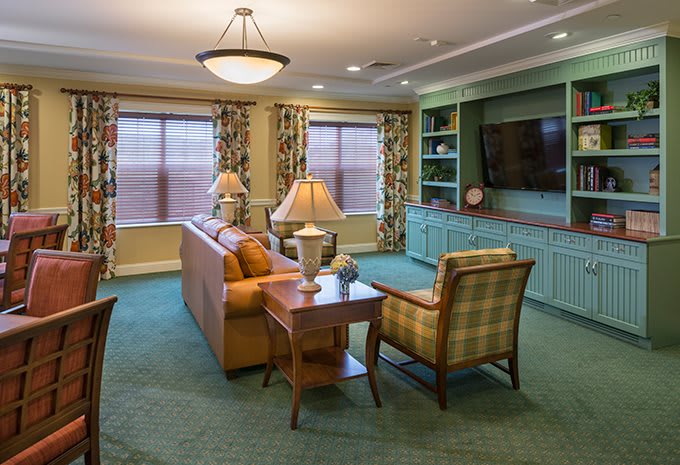 A cozy living room with comfortable seating and a large television.